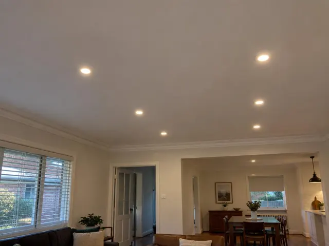 Ceiling with recessed downlights in a living and dining room with cream walls and windows in Minmi